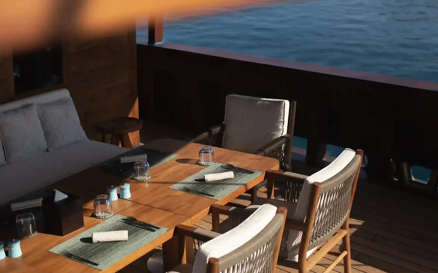 A crew-laid dining table on the deck of a charter yacht