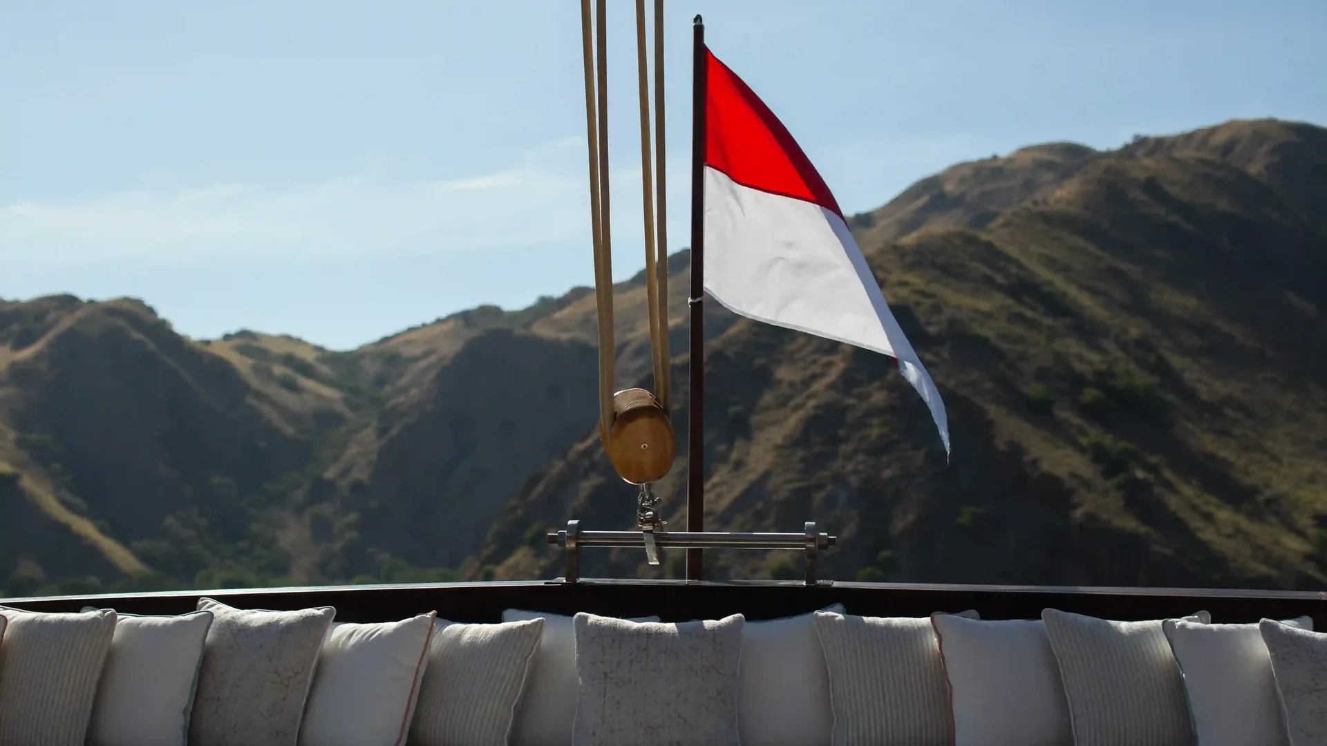The Indonesian ensign flying over the deck of a charter yacht in Komodo